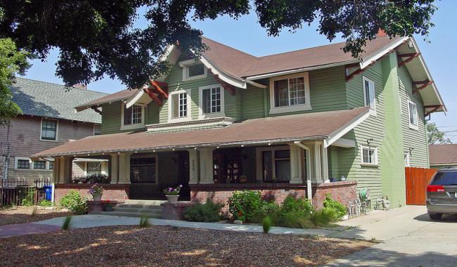 An image of an two story green-painted home