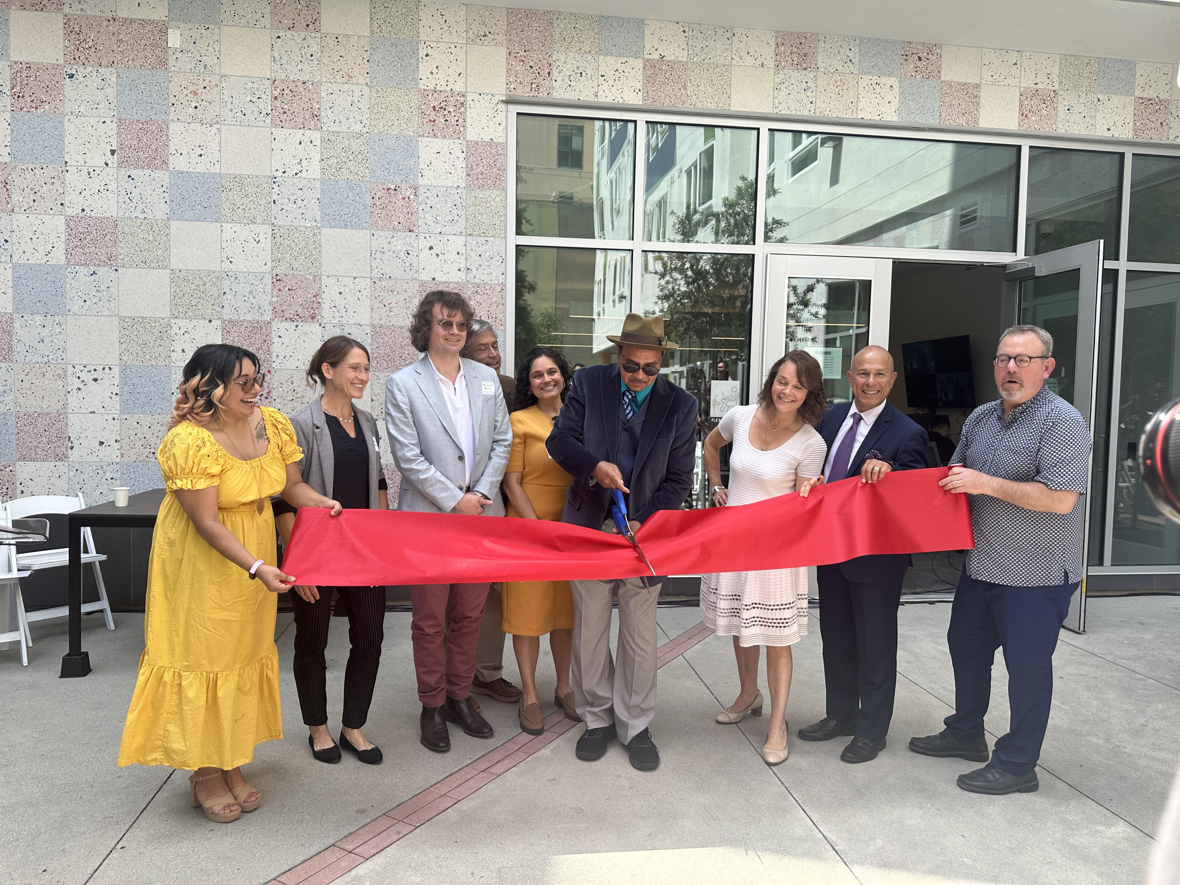 Group of people cutting a ribbon