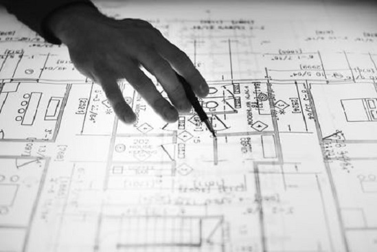 Architectural Map with a hand on it